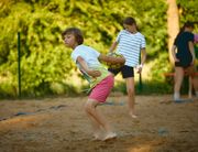 Kid throws a volleyball